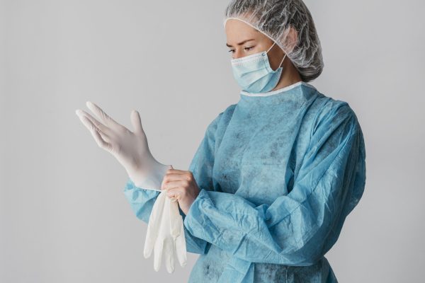 doctor-putting-surgical-gloves